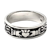 Silver claddagh band ring with intricate design on a white background